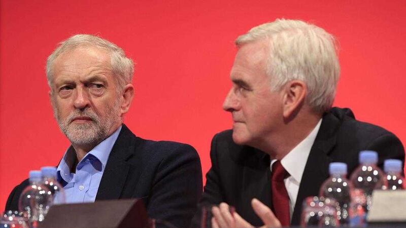 RETRANSMITTED CORRECTING BYLINE.Labour leader Jeremy Corbyn (left) looks toward shadow chancellor John McDonnell on stage during the second day of the Labour Party conference in Brighton, Sussex.  PRESS ASSOCIATION Photo. Picture date: Monday September 28, 2015. See PA LABOUR stories. Photo credit should read: Jonathan Brady/PA Wire. 