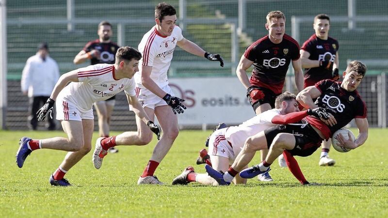 Louth&#39;s James Califf knocks Down forward Conor Poland to the turf in P&aacute;irc Esler. Picture by Philip Walsh 