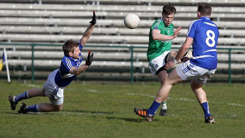 Fermanagh's Tomas Corrigan gets his shot away despite the best efforts of Laois' Mark Timmons and Kieran Lillis<br/>Picture by Philip Walsh&nbsp;