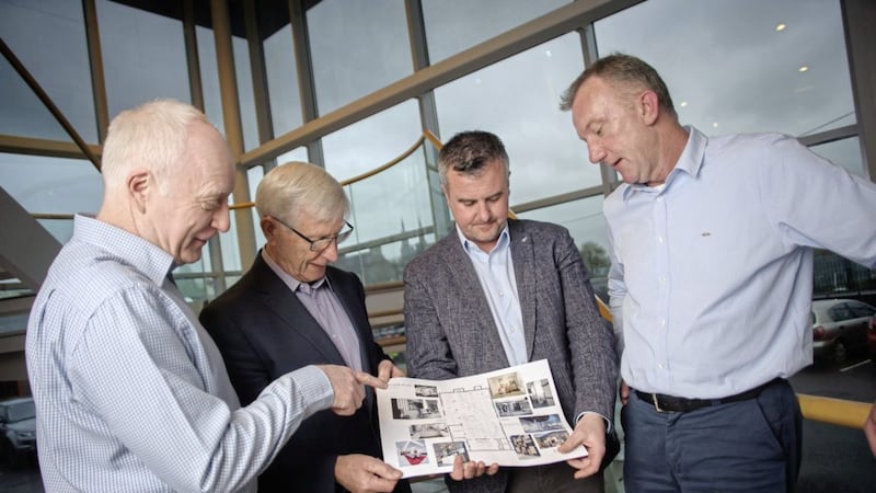 Reviewing plans for Armatile&#39;s Dublin showroom are (from left) Conor Moore (finance director), Seamus McCann (chairman and founder), Chris McCann (retail director) and Derek Tynan (area sales manager) 