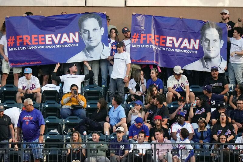 Supporters of Wall Street Journal reporter Evan Gershkovich hold a sign for him during the third inning of a baseball game between the New York Mets and the New York Yankees