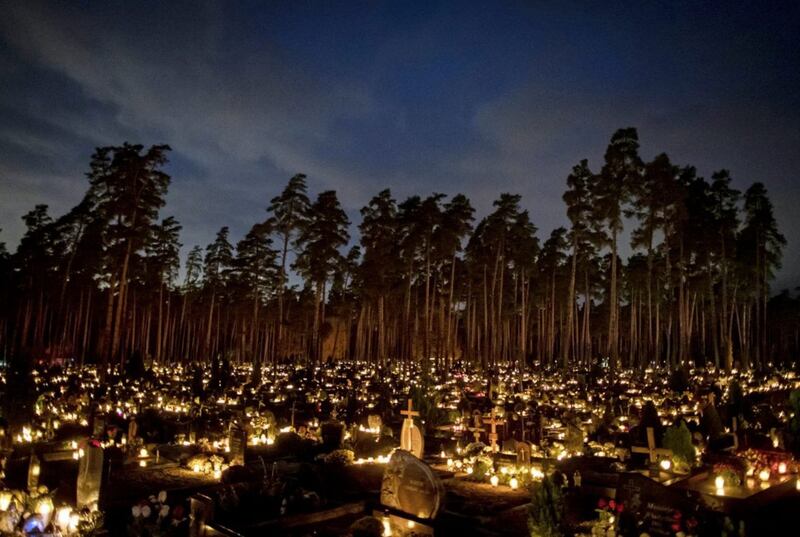 Relatives gather around graves illuminated by candles on All Saints&#39; Day at a cemetery in Vilnius, Lithuania on Sunday. Picture by AP Photo/Mindaugas Kulbis 