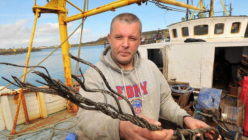 The Karen&#39;s skipper Paul Murphy holding a snapped steel cable after a British submarine snagged his trawler&#39;s nets.  Picture by Justin Kernoghan 