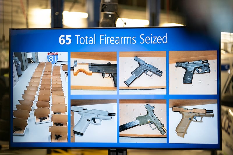 A photo of firearms seized is displayed during a news conference regarding an investigation into the theft of gold from Toronto’s Pearson International Airport (Arlyn McAdorey/The Canadian Press via AP)