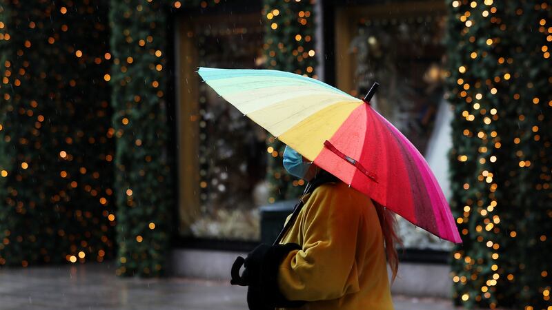 &nbsp;A woman using an umbrella walks down a quiet Grafton street on a rainy day in Dublin's city centre.