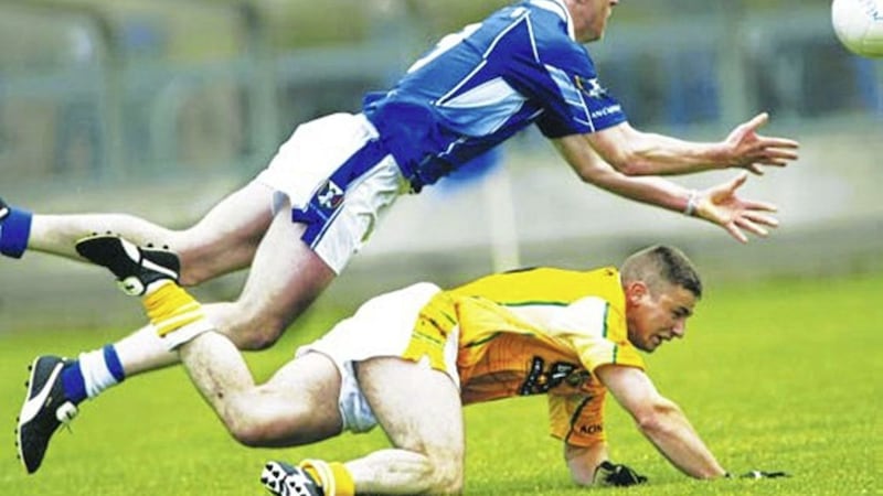 HURDLING THE CHALLENGE: Cavan&rsquo;s Pierce McKenna dives over Tony Scullion of Antrim as he makes a pass during the drawn Ulster SFC first round encounter at Kingspan Breffni Park on Sunday May 29 2005 