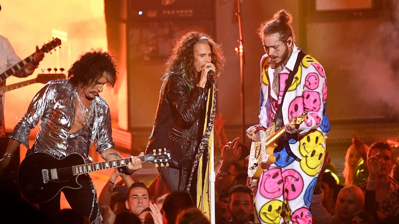 Aerosmith’s Steve Tyler, centre, performs with Post Malone, right, and Joe Perry (PA)