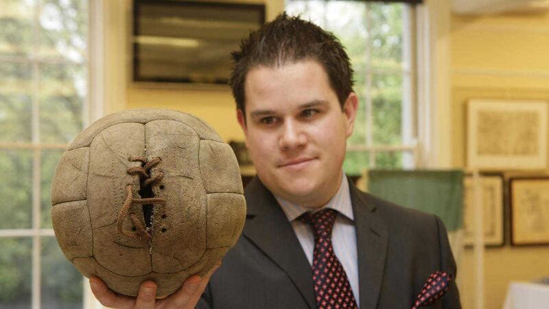 George Mealy holds the Bloody Sunday match ball before a 2009 auction. Picture by Niall Carson 