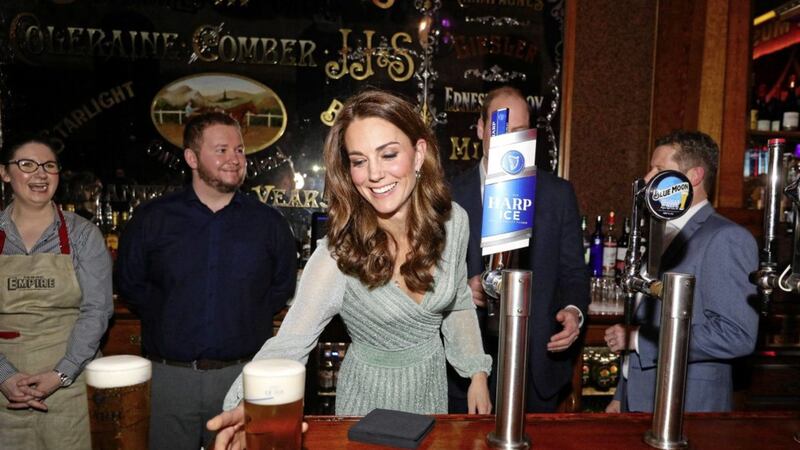 The Duchess of Cambridge pulls a pint with the Duke of Cambridge during their visit to the Empire Music Hall in Belfast. Picture by Aaron Chown, Press Association 