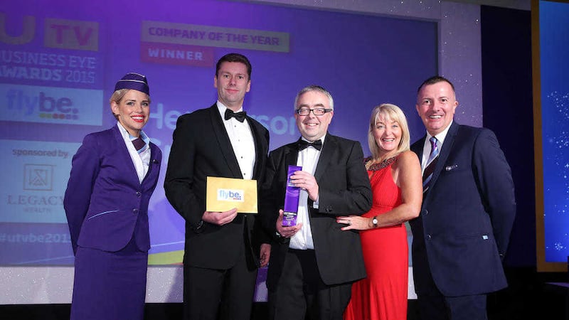 Martin Agnew, managing director of Henderson Group, receives the Company of The Year Award from Keith Liggett of category sponsor Legacy Wealth. Included are Brenda Buckley of Business Eye and Flybe cabin crew Lesley Johnston and Ken Boyd. Picture: Kelvin Boyes / Press Eye 