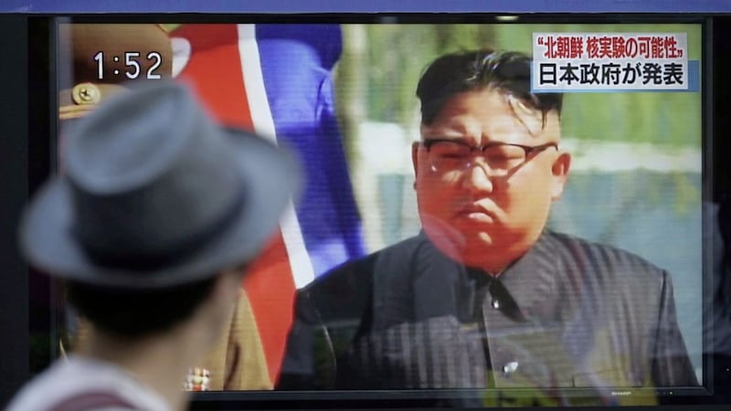 A man watches a TV news program on a public screen showing an image of North Korean leader Kim Jong Un while reporting North Korea&#39;s nuclear test in Tokyo on Sunday. Picture by Eugene Hoshiko, Associated Press 