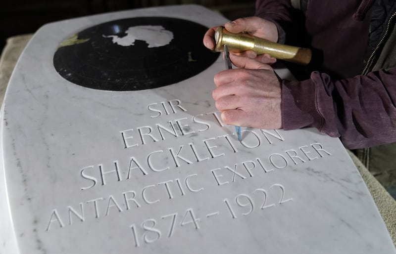 Stonemason Will Davies adds the finishing touches to a memorial stone for Sir Ernest Shackleton, ahead of a dedication in Westminster Abbey on February 15