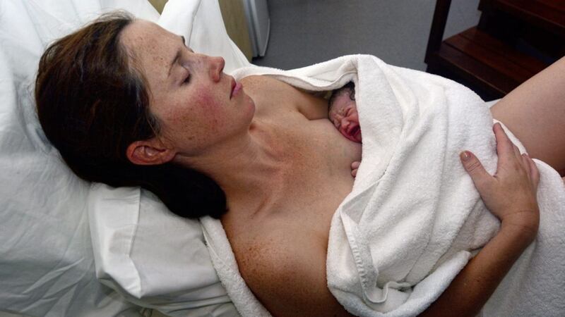 Irish midwife Bridget Sheeran encourages mothers to prepare early for a stress-free childbirth experience. Pictured is a mother resting with her newborn baby in bed immediately after a natural water birth labour. 