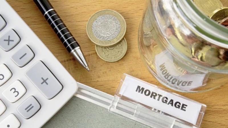 Mortgage file with calculator, pen, coins and glass jar. 