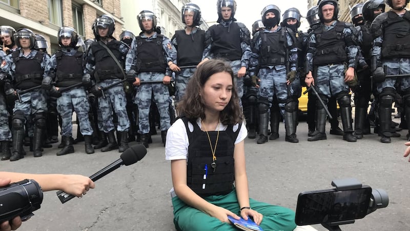 ‘She’s just one tired girl against the police,’ said photographer Alexei Abanin.