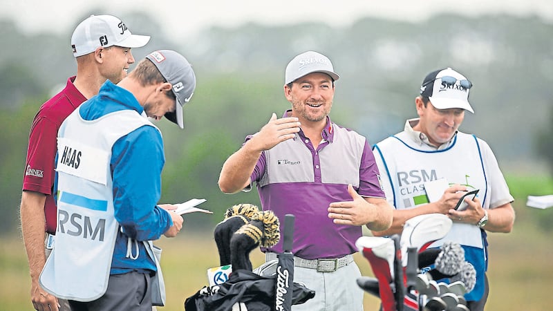 Tee-hee: Graeme McDowell shares a joke with playing partner Bill Haas on the third tee during the opening round of the RSM Classic at Sea Island in Georgia yesterday. The Portrush man, who won the OHL Classic in Mexico on Monday, signed for an opening three-under-par round of 67 to claim a share of 42nd place, four shots adrift of leader Kevin Kisner <span class="Apple-tab-span" style="white-space: pre;">	</span> &nbsp; &nbsp; &nbsp; &nbsp; &nbsp;Picture: AP