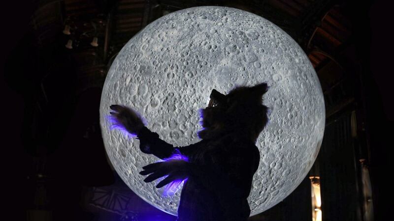 A werewolf warms up against the Museum of The Moon at the Guildhall in Derry as the city&#39;s Halloween celebrations get underway. Picture by Margaret McLaughlin 