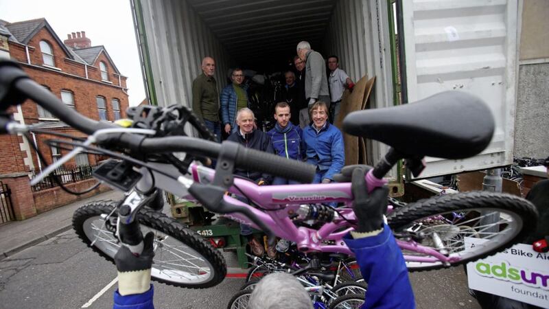 David MacCauley, Brendan McCartan, Colin Kirkpatrick and other helpers with the Adsum Foundation based in Belfast&rsquo;s Ormeau Road stack hundreds of bikes into a container bound for Madagascar Picture: Mal McCann 