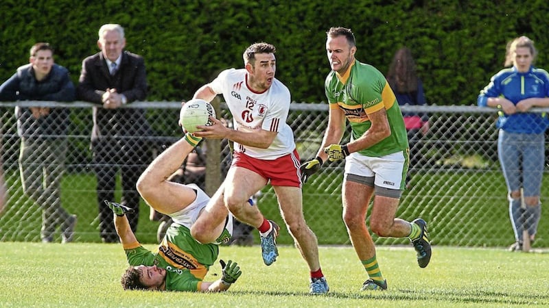 Lamh Dhearg&#39;s Conor Murray gets away from Creggan&#39;s Richard Johnston and Conor McCann Picture by Seamus Loughran 