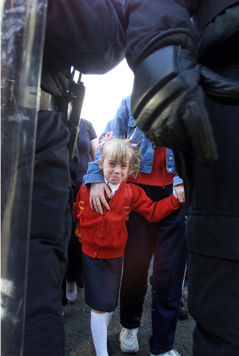A young girl on the way to Holy Cross School in Ardoyne, north Belfast, during a loyalist protest in 2001 and 2002.  Picture by Hugh Russell 