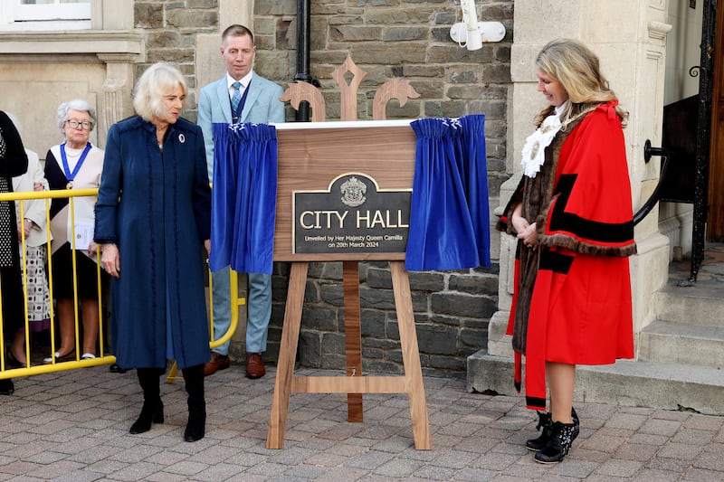 Queen Camilla unveils a commemorative plaque outside of Douglas Borough Council after conferring city status on the Borough of Douglas