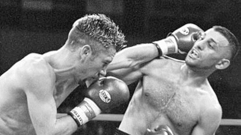 AT CLOSE QUARTERS...Wayne McCullough and Naseem Hamed get to grips with each other during their WBO featherweight title clash in Atlantic City 