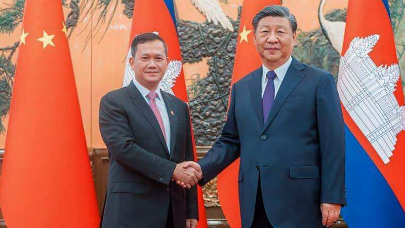 Cambodian Prime Minister Hun Manet, left, shakes hands with Chinese President Xi Jinping (Cambodia’s Prime Minister Telegram via AP)