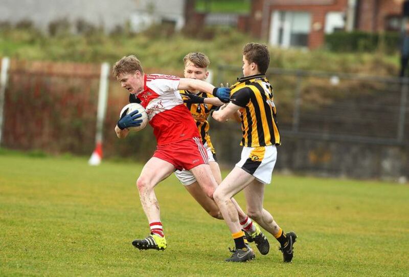 Kilrea's Kevin Quinn  comes under pressure  from Crossmaglen's Cormac Donnelly and Rian O'Neill   in Saturday's Ulster Minor Football game at St Paul's Belfast   &nbsp;
