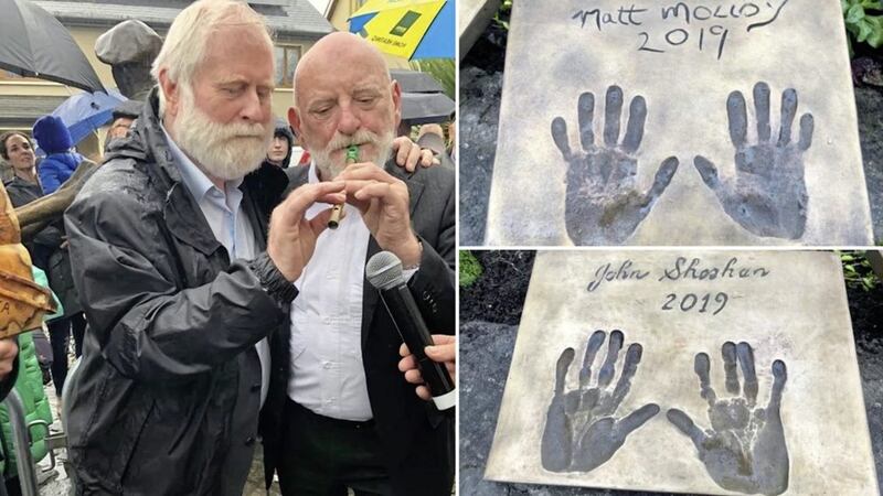 John Sheahan of the Dubliners and Matt Molloy of the Chieftains at the Cong Food Festival, and right, their hand prints. Pictures from RT&Eacute; 