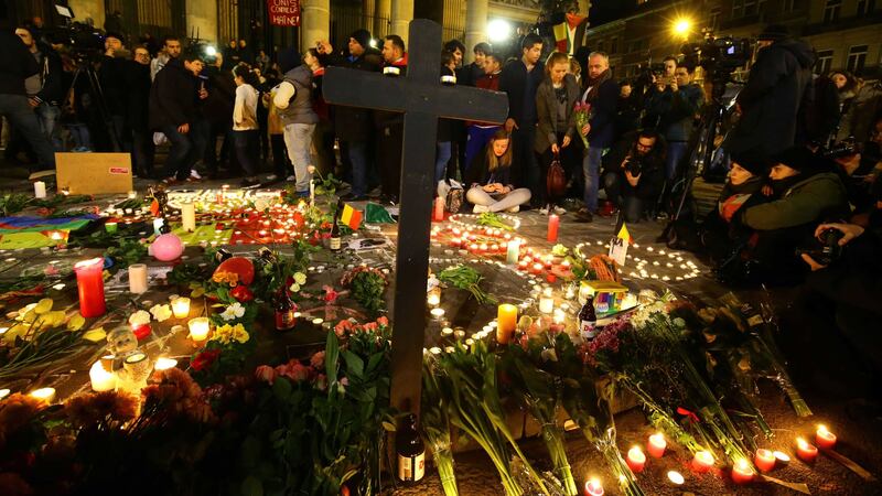 Members of the public gather at the Place de la Bourse in Brussels to leave messages and tributes following the terrorist bomb attacks. Picture by Gareth Fuller, Press Association