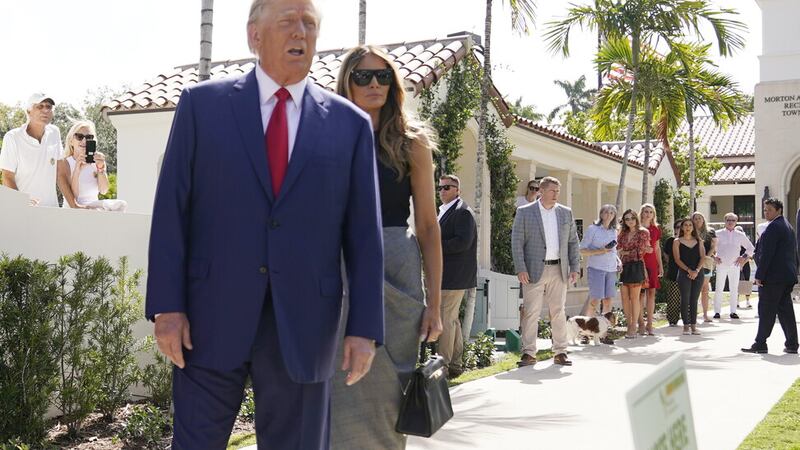 Former President Donald Trump talks to the media with Melania Trump, after voting at Morton and Barbara Mandel Recreation Center on Election Day, Tuesday, Nov. 8, 2022, in Palm Beach, Fla. (AP Photo/Andrew Harnik)