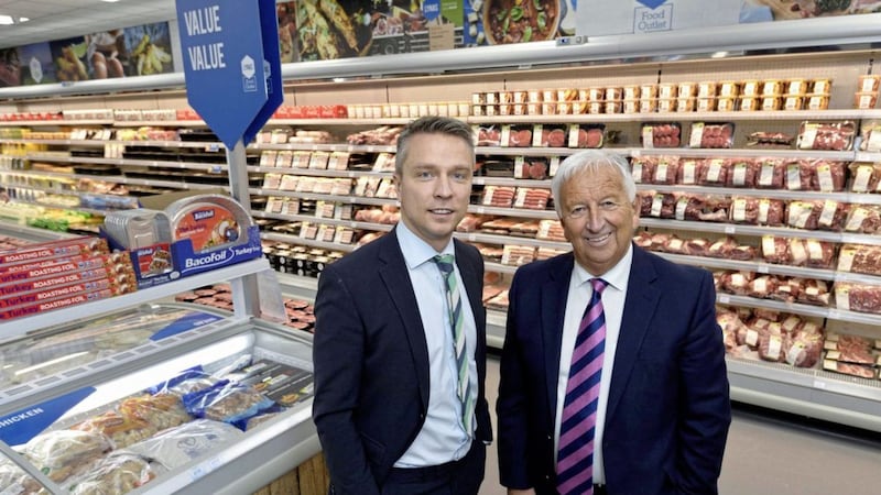 Andrew Lynas, managing director of Lynas Foodservice and the group&rsquo;s chairman, Norman Lynas, are pictured at the opening of the new Lynas Food Outlet on the Boucher Road in Belfast. 