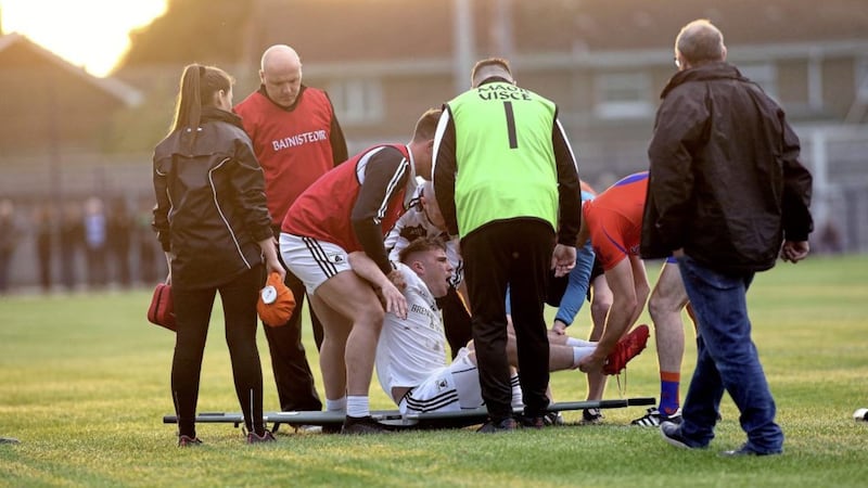 Tyrone and Clonoe forward Connor McAliskey is helped onto a stretcher by medical staff after suffering a broken ankle in his club&rsquo;s Tyrone SFC first round defeat to Ardboe in Coalisland. Picture by Seamus Loughran