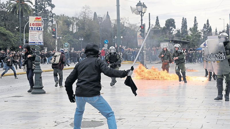 Protesters clash with riot police in the Greek capital Athens during the nationwide general strike. Picture by Associated Press&nbsp;
