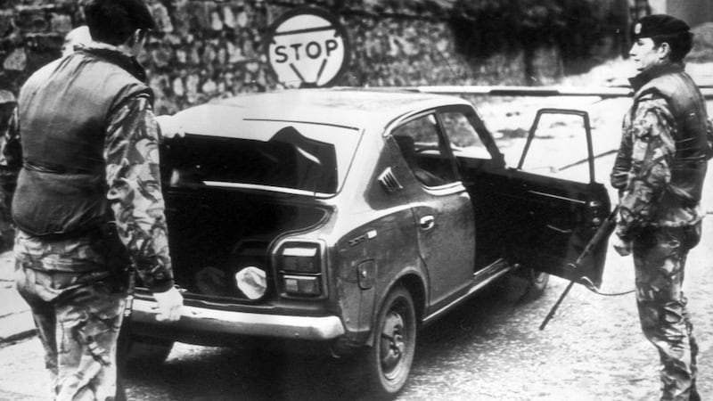 British soldiers search a car at the South Armagh border in the wake of the massacre of 10 Protestant workers at Kingsmills in 1976