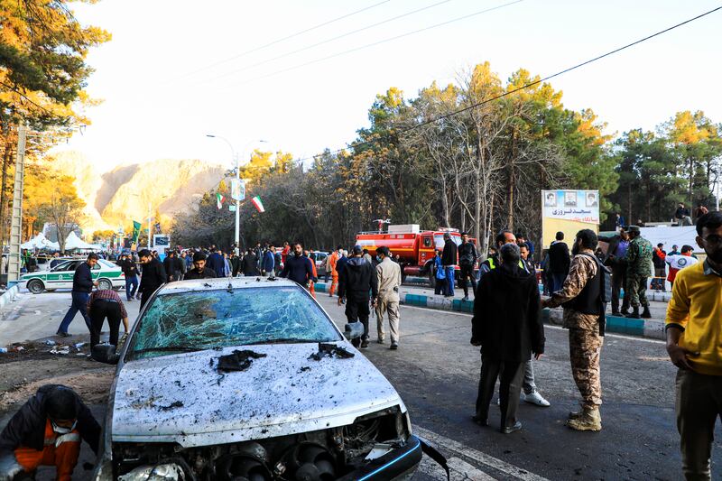 People gather at the site of an explosion in the city of Kerman (Sare Tajalli/ISNA via AP)