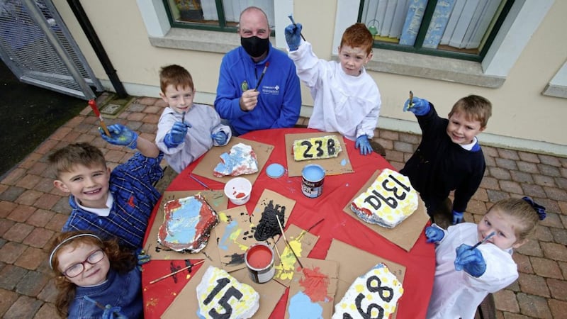 Primary three pupils from Our Lady&#39;s Primary School, Tullysaran take part in a project painting reclaimed stones from a demolished local bar with door numbers so emergency services can find addresses easier. Pictured also is Aidan Early, Community First Responders. Picture by Mal McCann 