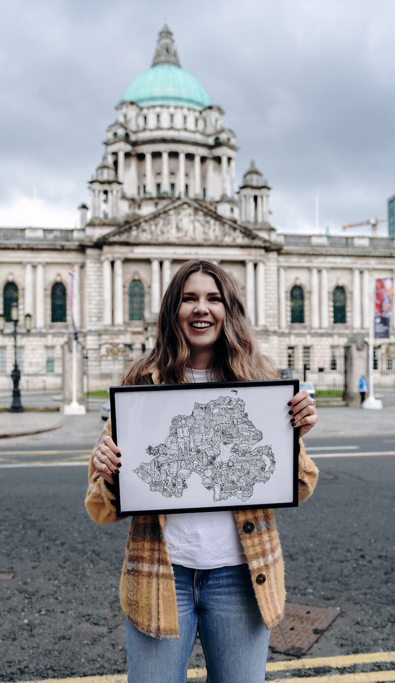 Danni Simpson pictured with her illustration of Northern Ireland outside Belfast City Hall