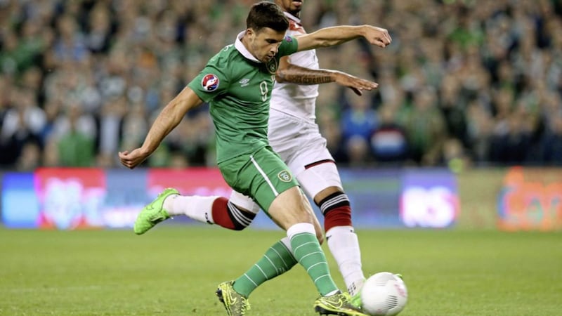 Republic of Ireland&#39;s Shane Long (centre) scores during the UEFA European Championship Qualifying match at the Aviva Stadium, Dublin in October 2015. Photo: Brian Lawless/PA Wire. 