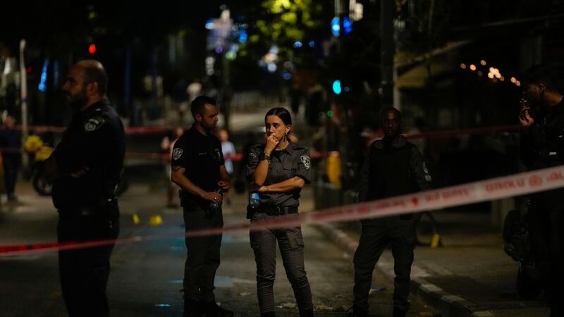 Israeli police inspect the site of a shooting attack in Tel Aviv (Maya Alleruzzo/AP)