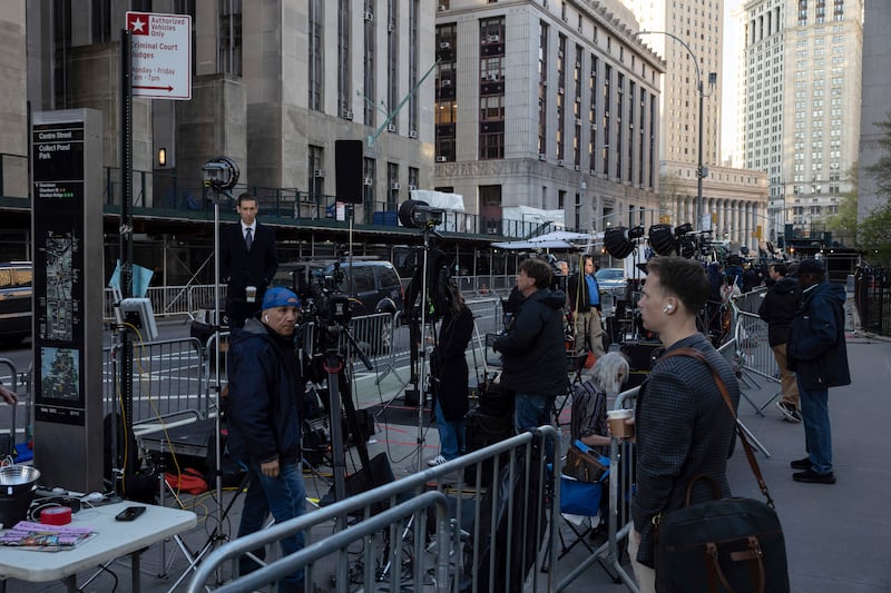 Members of the media gather outside Manhattan Criminal Court in New York (Yuki Iwamura/AP)