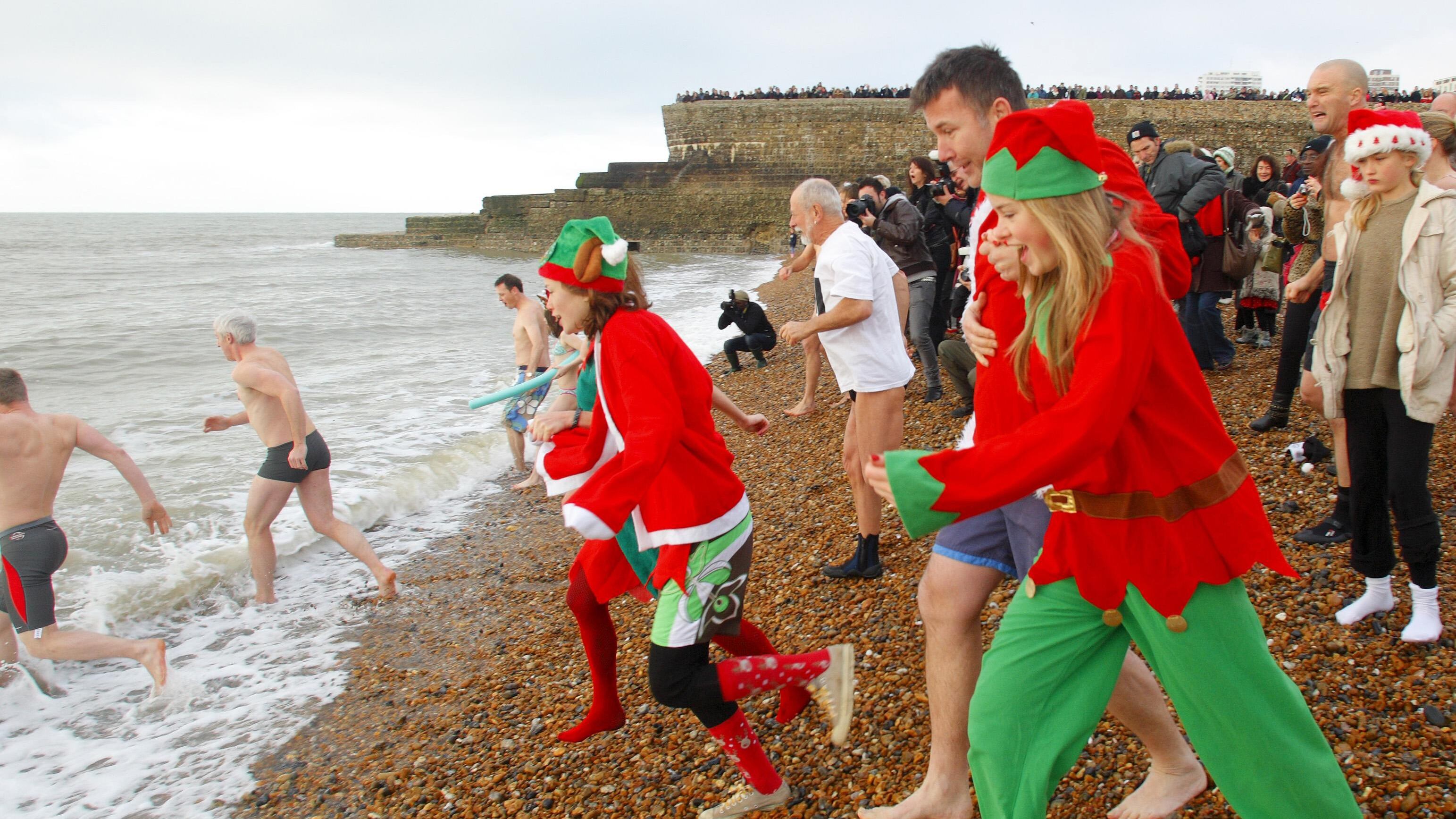 Swimmers heading into the sea at a Christmas Day dip in Brighton last year