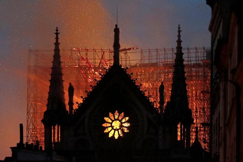 Flames and smoke rise from Notre Dame cathedral, pictured on April 15 2019 as the devastating fire took hold. Picture by AP Photo/Thibault Camus