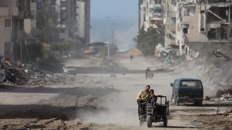 Palestinians drive through Gaza City (Mohammed Hajjar/AP)