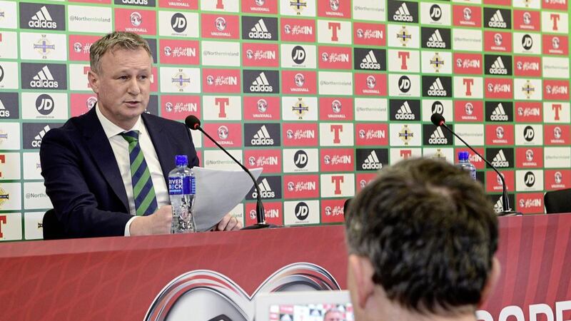 Northern Ireland manager Michael O&#39;Neill reads from a prepared statement about the issue of international allegiance switches. 