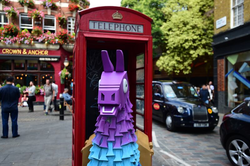A Fortnite Loot Llama in a red telephone box on Neal Street in Covent Garden, London