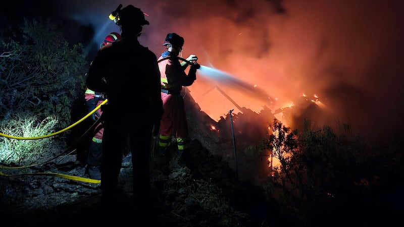Military Emergency Unit personnel work to extinguish a forest fire the Canary island of La Palma (UME via AP)