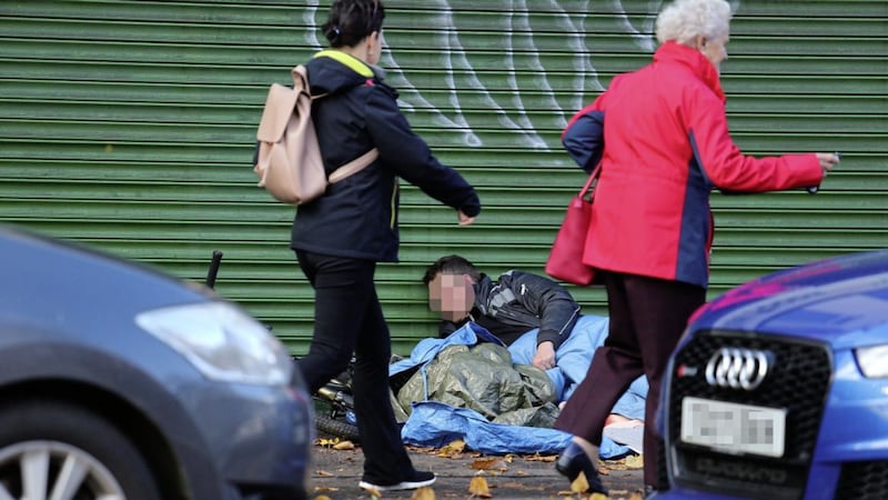 A homeless man wrapped in a sleeping bag on on the Upper Ormeau Road Picture Mal McCann. 