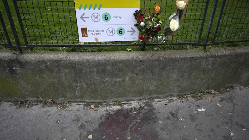 Flowers at the scene near the Eiffel Tower where a man targeted passers-by late on Saturday (Christophe Ena/AP)
