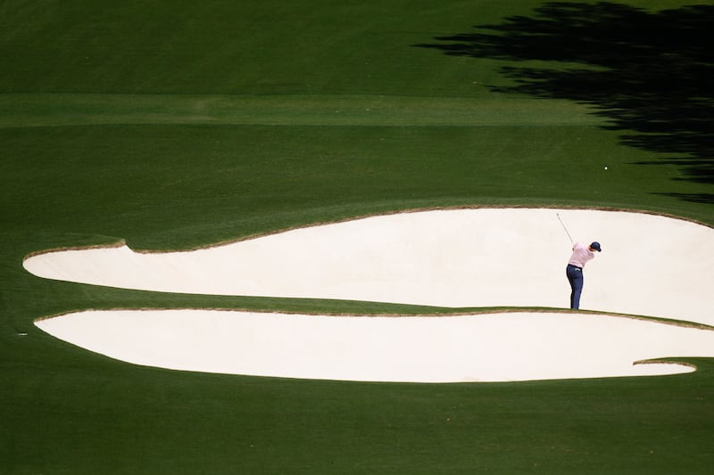 Rory McIlroy hits from the bunker on the eighth hole during his third round at the Masters (Charlie Riedel/AP)